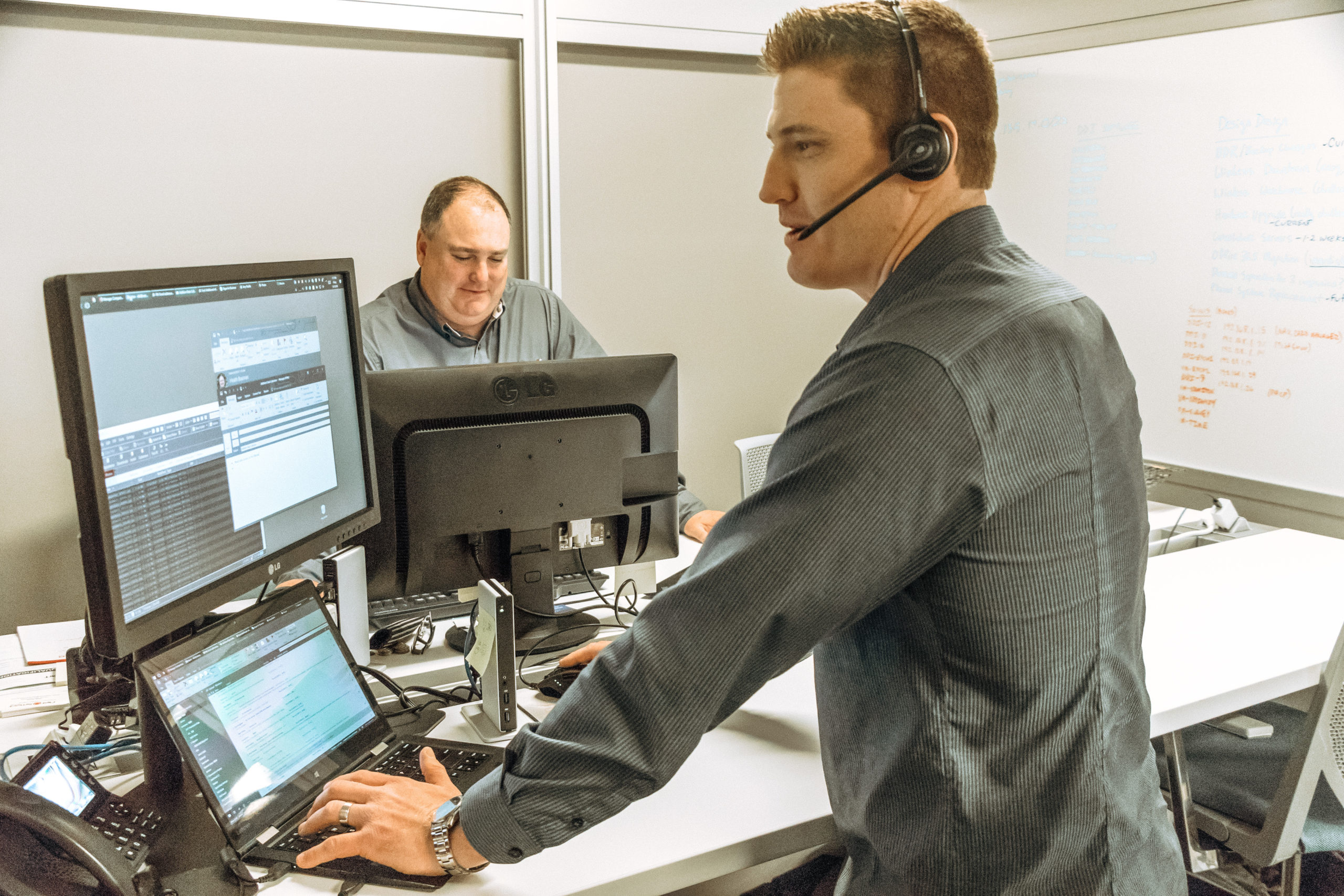 Tech guys working on computers with headsets