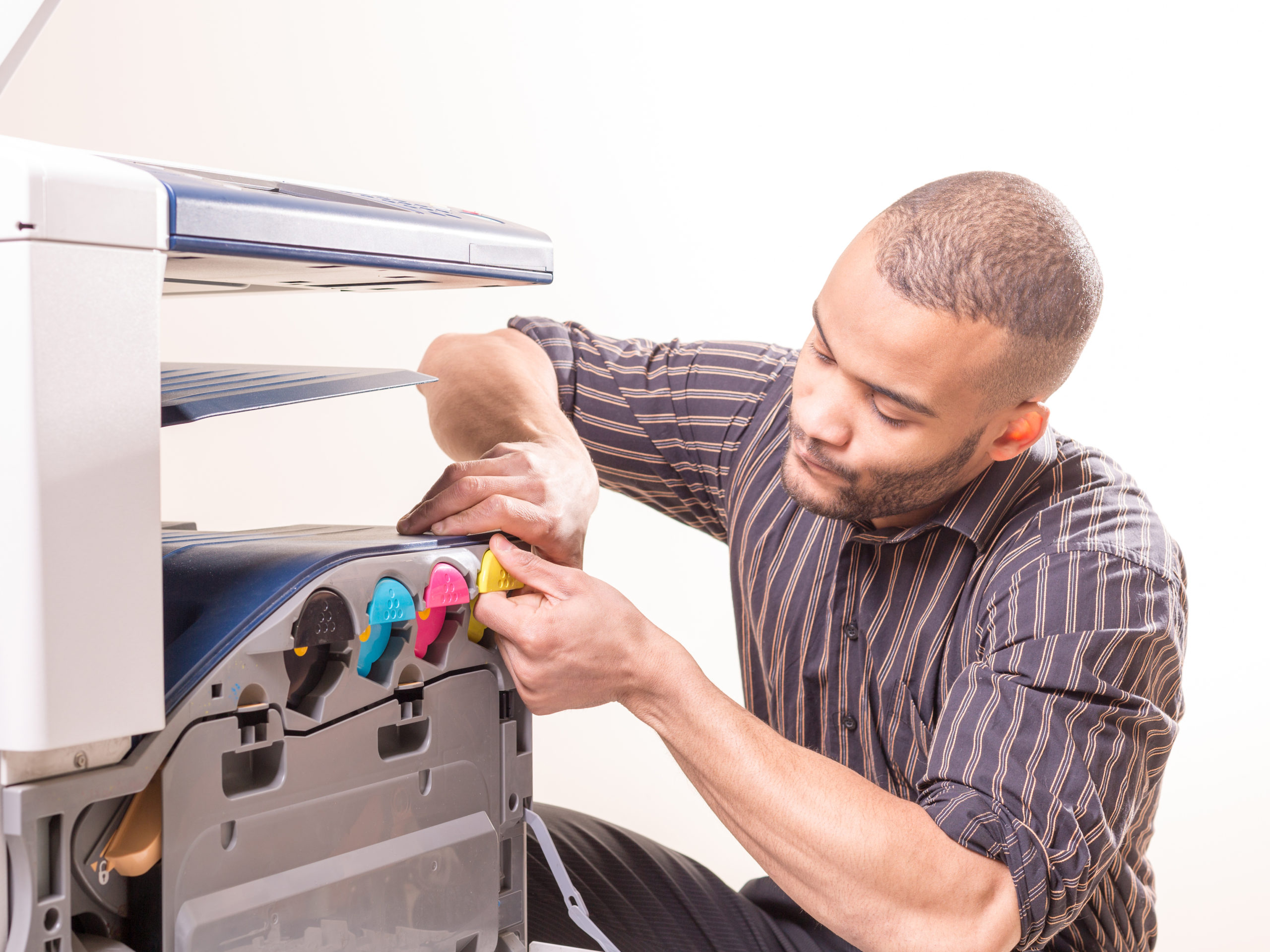 black man fixing copier