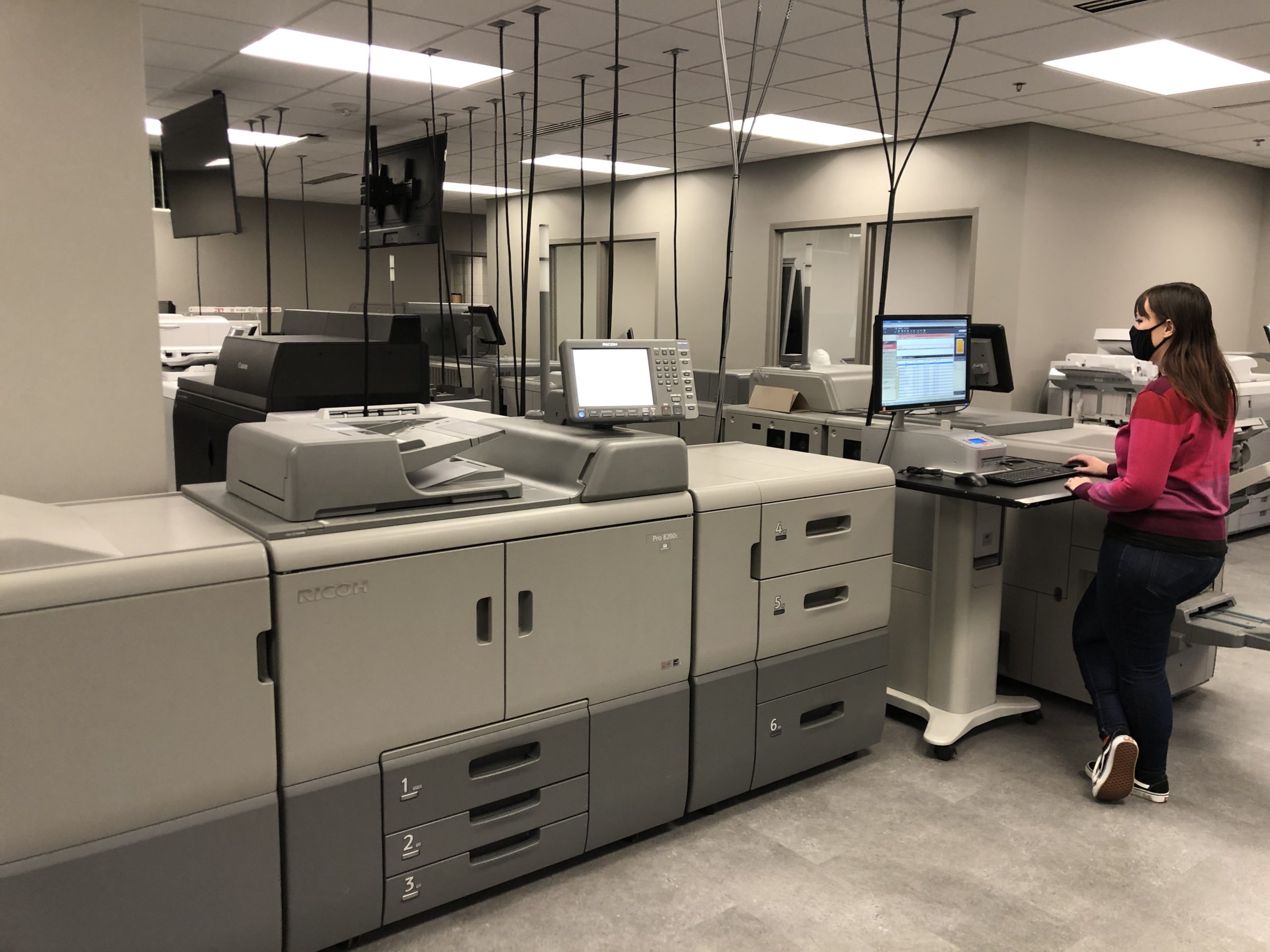 Photo of employee using production printer