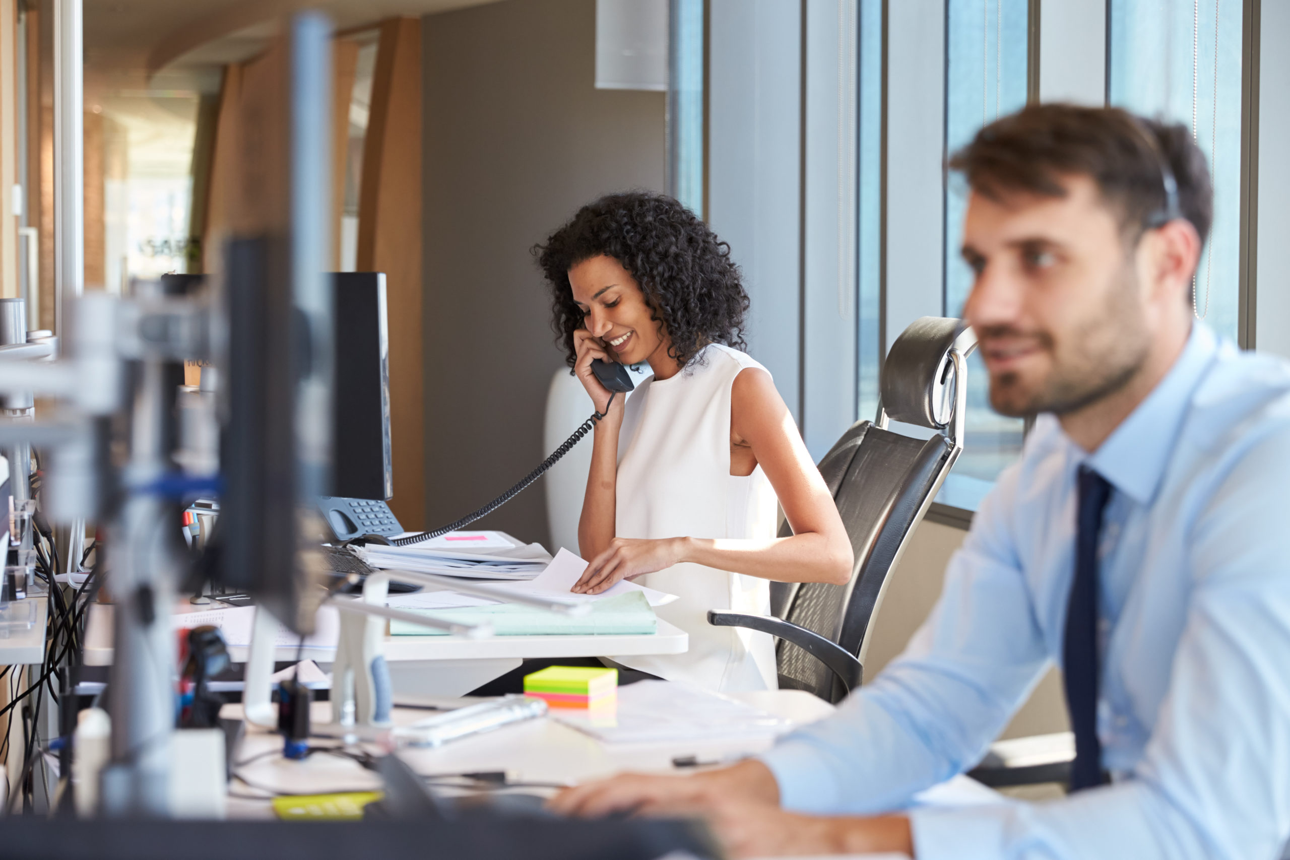 Photo of businesswoman on office desk phone