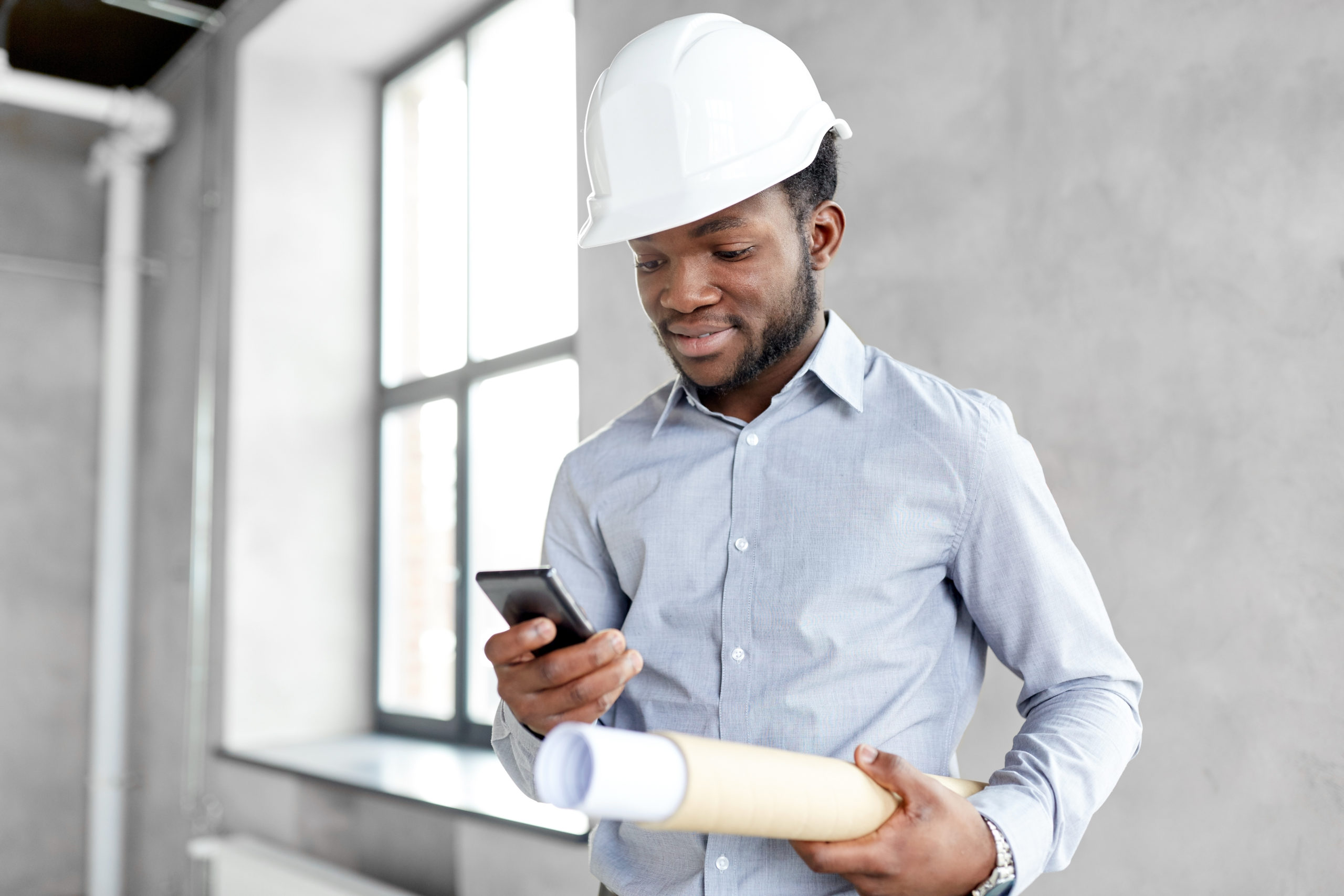 photo of african american construction worker and architect in hardhat