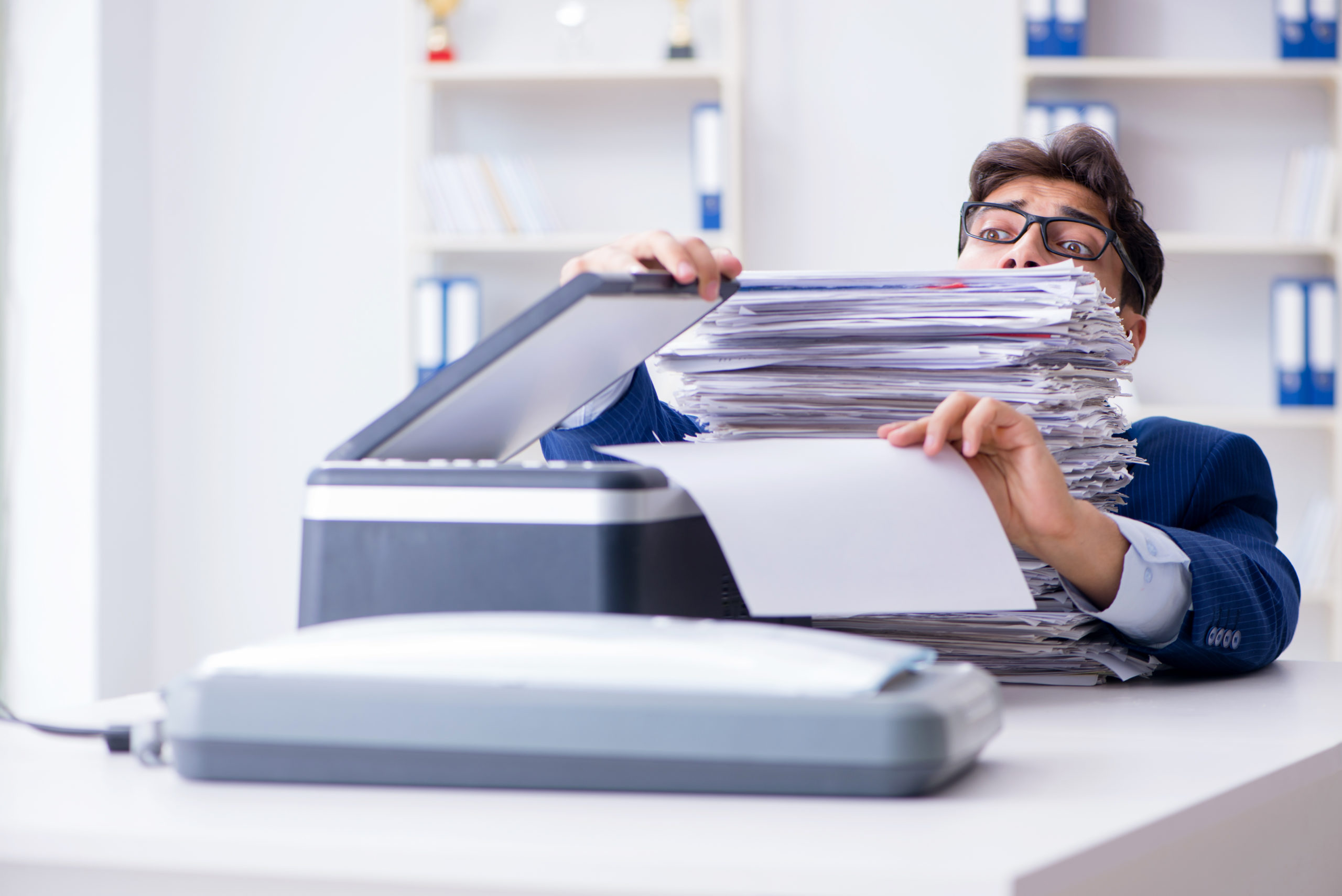 Businessman scanning in a pile of documents