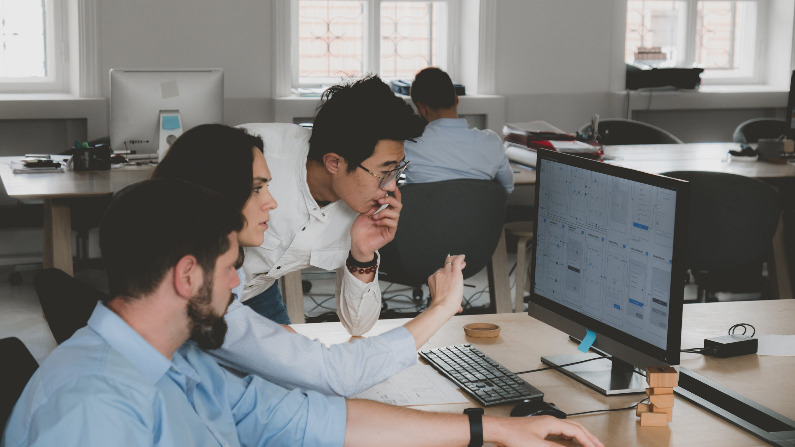 photo of multi racial business people working on computer