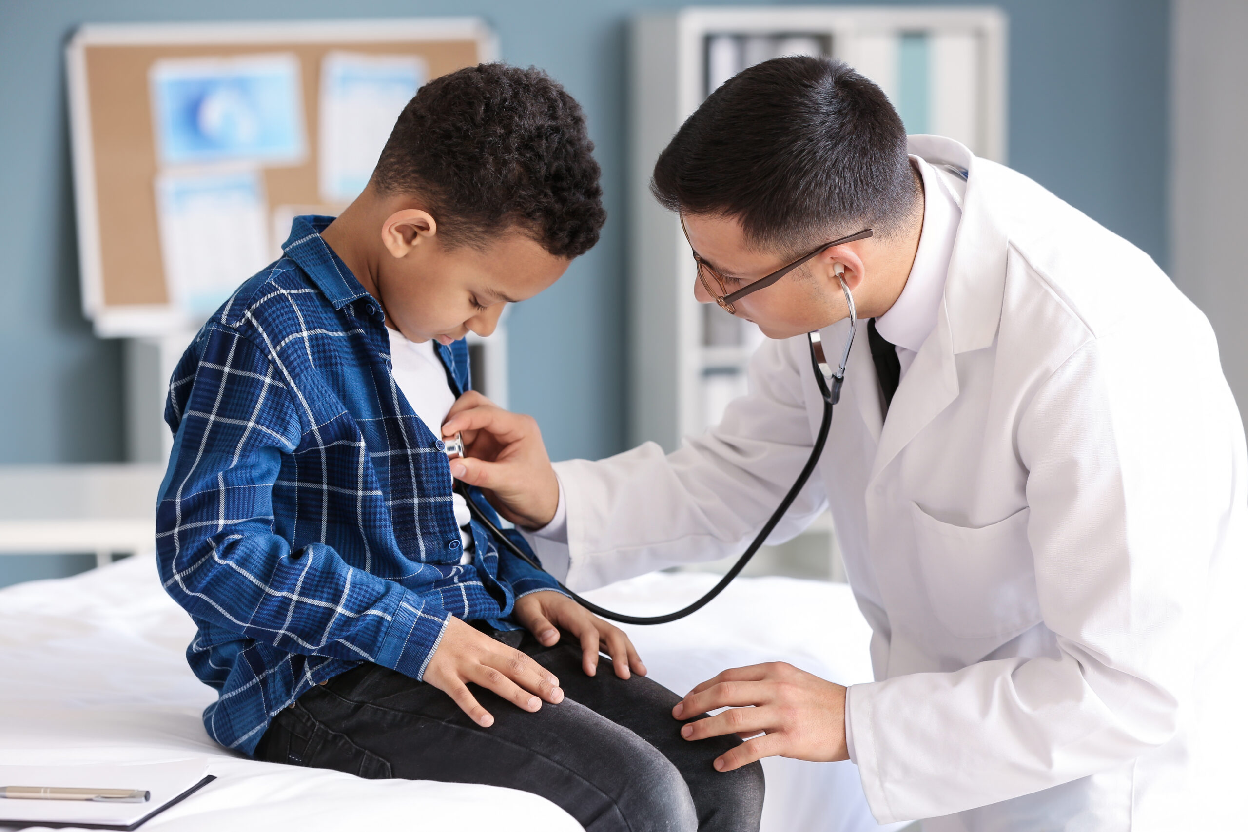 Pediatrician examining pediatric patient