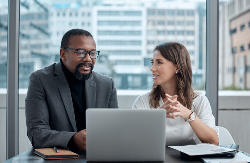 Corporate business colleagues talking in front of laptop
