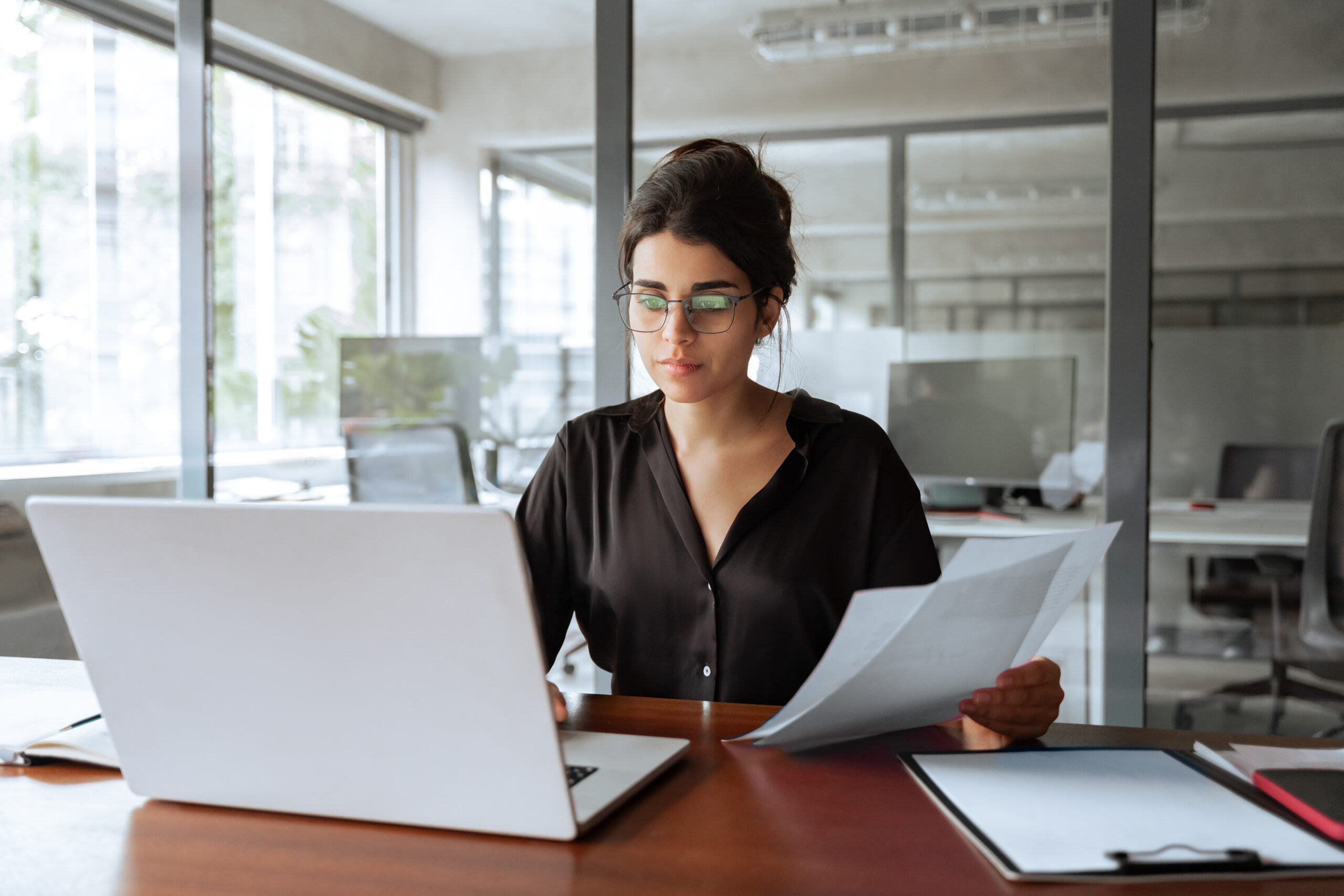 Focused business woman working on laptop