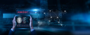 Analyst holding a tablet with network security data on the screen: firewall protection, intrusion detection, vulnerability monitoring, secure access, digital defense system governance, and safety.