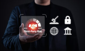 Third-party risk management concept. Businessman holding virtual gauge with handshake icon, highlighting partnership risk, compliance, cybersecurity, and regulatory challenges in business.