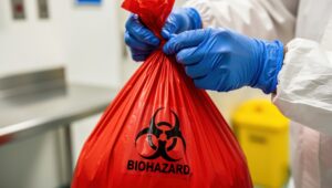 Biomedical waste disposal container and biomedical waste disposal bag in a healthcare facility.