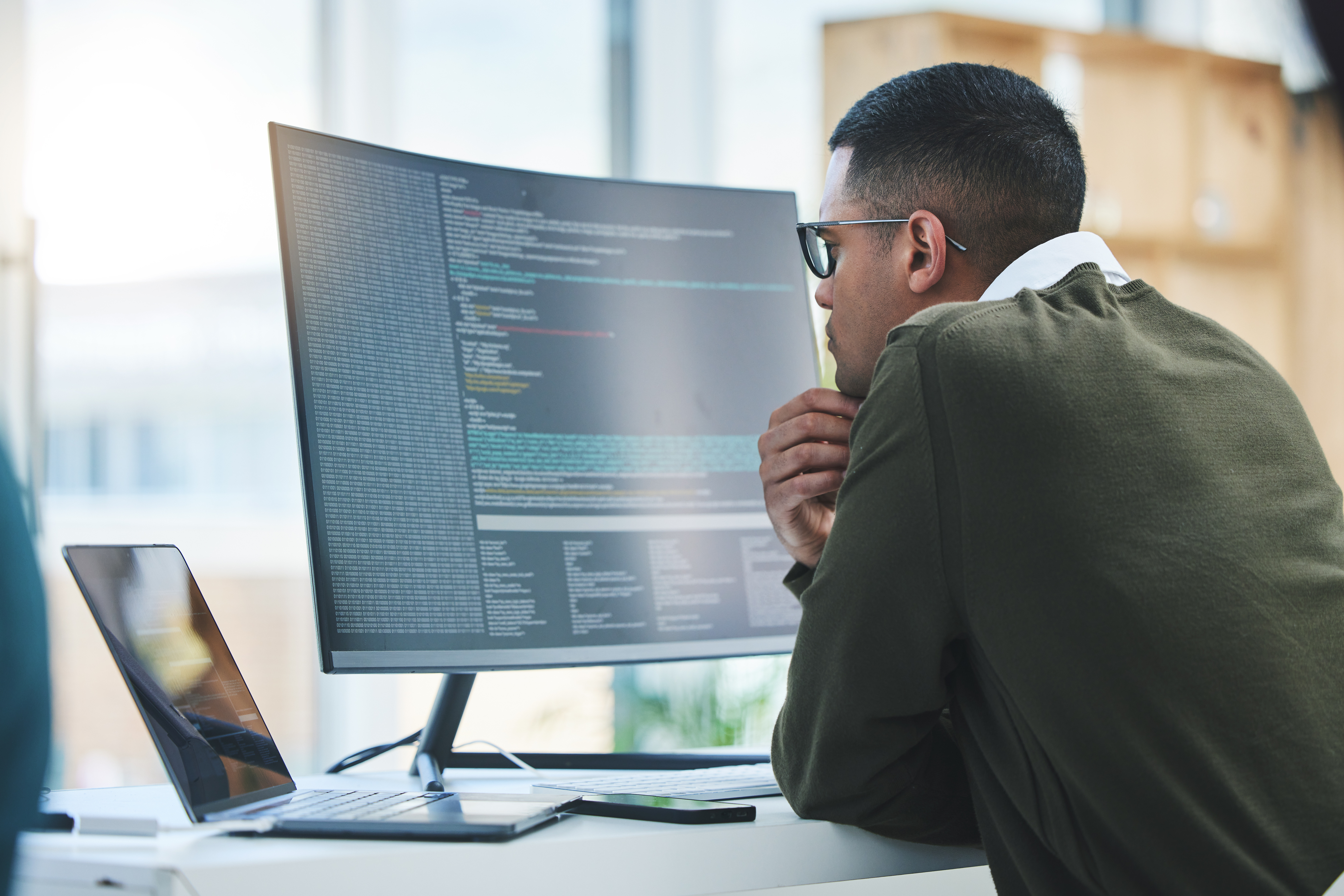 5 Cybersecurity Risks Small Businesses Can't Afford to Ignore - Man looking at computer screen