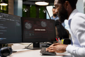 System administrator fighting to stop hacker intrusion in office from ransomware