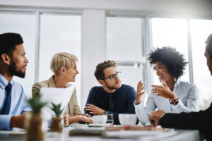 Group of business professionals around a table collaborating.